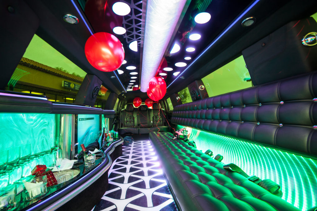 The inside of a limousine decorated with balloons